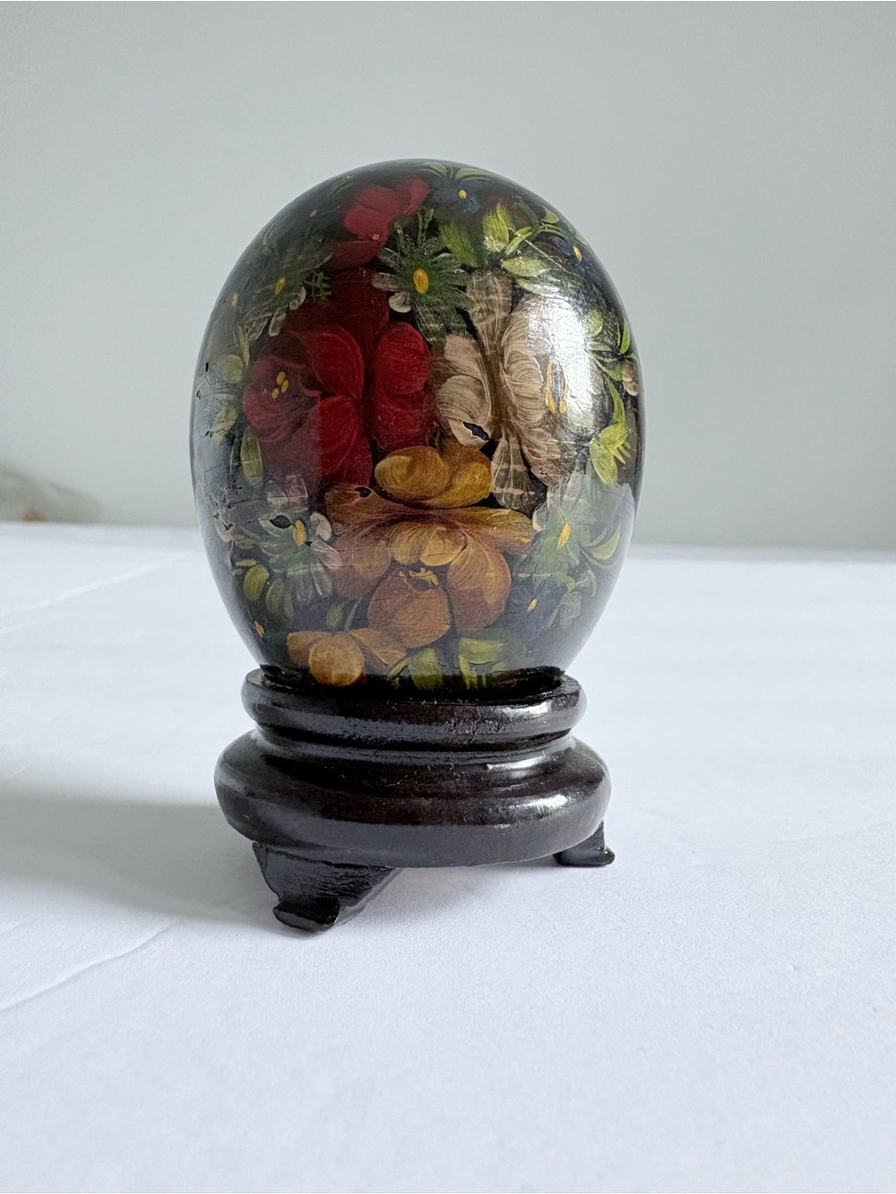 Hand-Painted Floral Lacquer Egg on Wooden Stand - Black Background